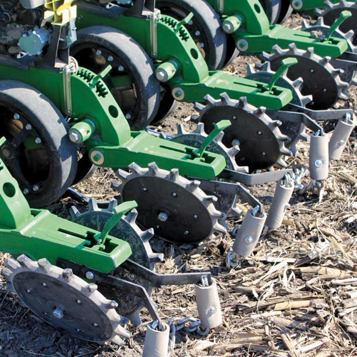 A row of Twister Closing Wheels installed on John Deere planter in the field