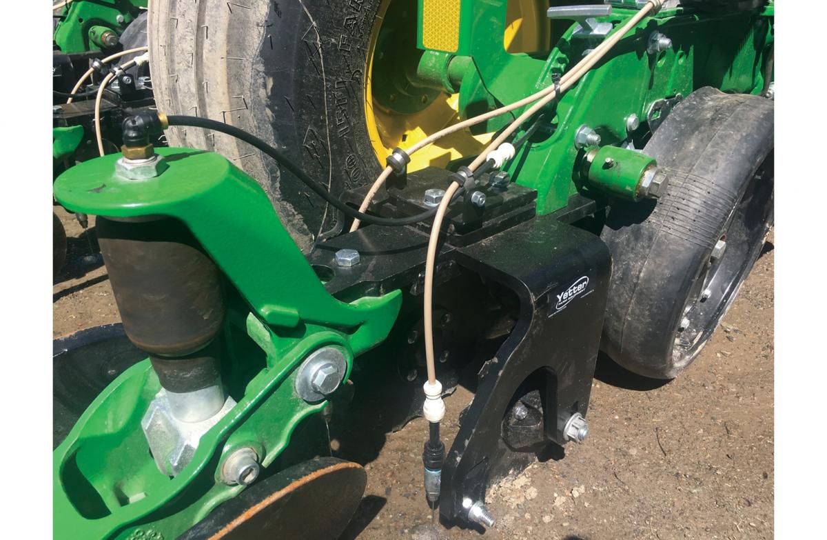 Dual wheel fertilizer placement planter attachment with tubes in dirt