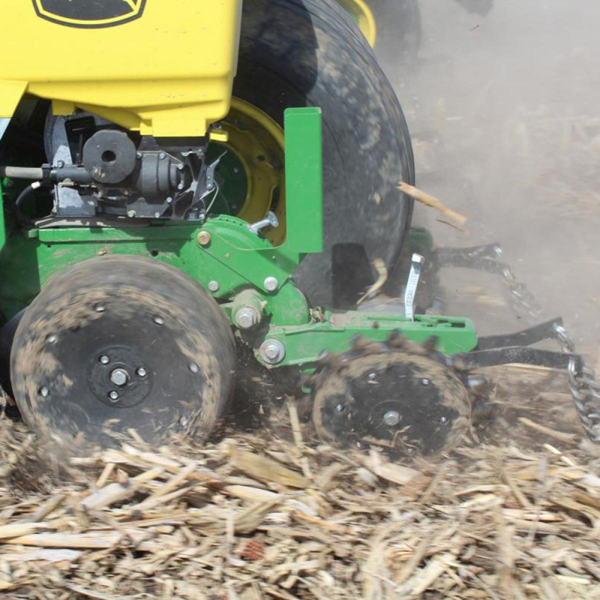 Twister Closing Wheel on John Deere planter in motion in field