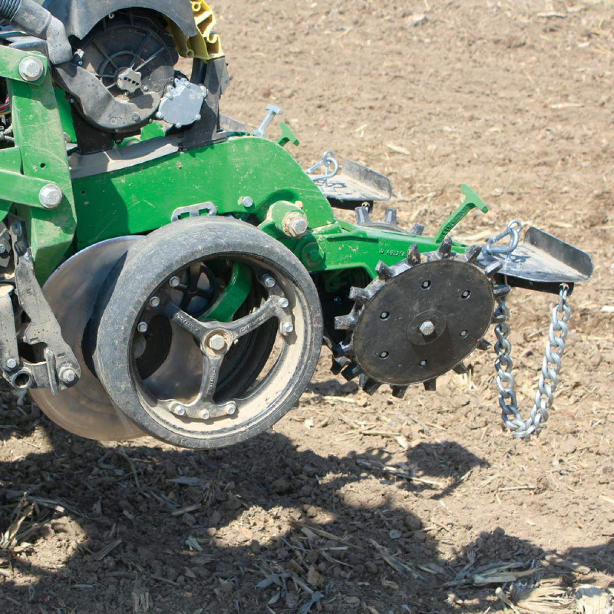 Drag Chain, Twister Closing Wheel, and Spoke Planter Gauge Wheel installed on John Deere planter in the field