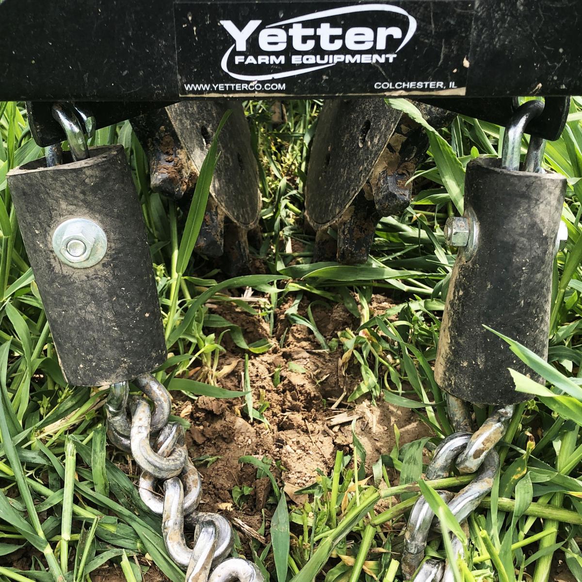 Twister closing seed trench in cover crops with drag chain.